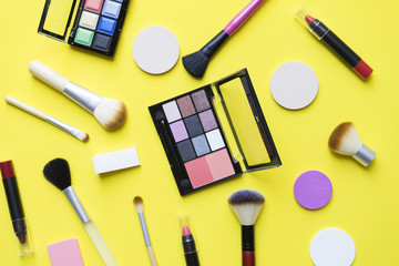 Set of colorful cosmetics on yellow background
