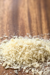 Panko Japanese flaky bread crumbs on wooden plate, photographed with natural light (Selective Focus, Focus one third into the image)