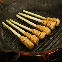Meat skewers on a grill pan
