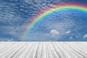 Wood terrace and Blue sky with rainbow