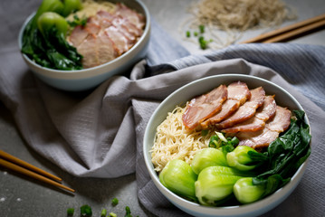 delicious egg noodle with red pork and vegetable in bowl