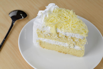 piece of cake with whip cream and grated cheese topping