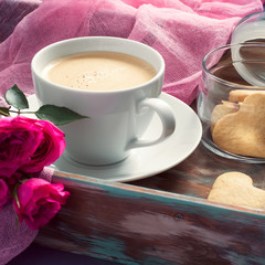Cup of coffee, cookies and rose. Concept of Valentine's Day brea