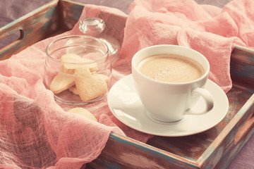 Cup of coffee and cookies in the shape of heart on tray. concept