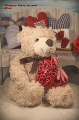 A teddy bear and a red heart. Teddy bear as a gift for Valentine. Happy Valentines day - vintage style - soft focus
