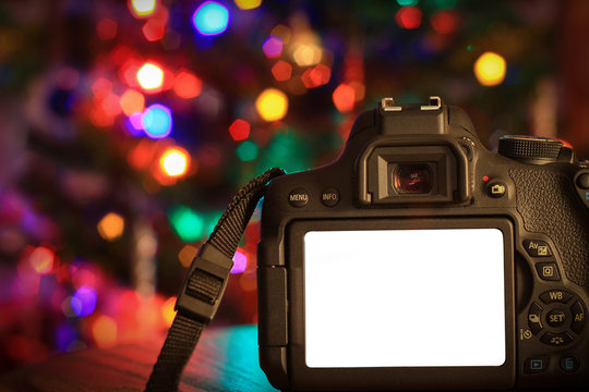 Christmas scene of a digital camera with a blank screen.