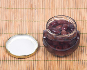 Cut beets in vinaigrette in jar on bamboo placemat