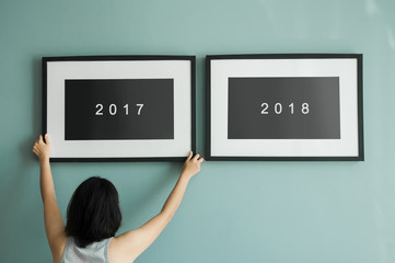 Woman holding picture frame. New year concept. 