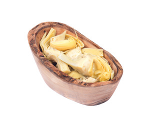 Food of love, marinated artichokes in olive wood bowl isolated on white background