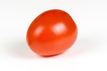 One red ripe tomato close up on a white background.