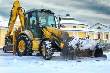 tractor for snow removal is parked on a city street