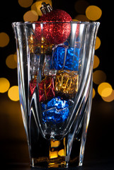 holiday decorations and lights in a glass vase