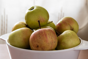 Wet apples in a white bowl 