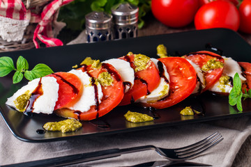 Caprese Salad on black plate