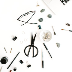 Flat lay, top view office table desk. Workspace with laptop, scissors, glasses, pen on white background.