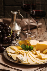 Refined still life of red wine, grapes and cheese