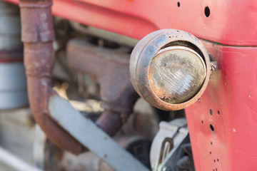 Fototapeta na wymiar Old tractor face, selective focus on it's light