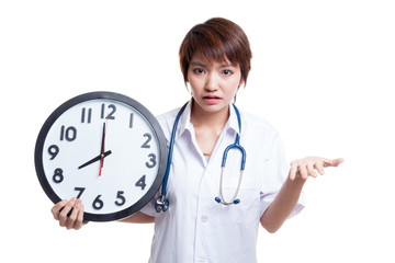 Angry Young Asian female doctor with a clock.