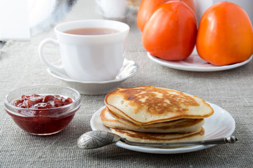 White plate with pancakes and vintage silver spoon