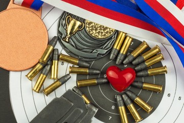 Concept of shooting competitions. Sport shooting. Biathlon background diploma. Tools and targets on wooden background. Caliber ,22
