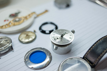 Detail of watch machinery on the table.