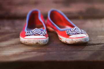 pair of red women's ballet shoes on a wooden background.