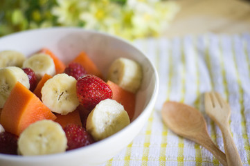 fruits salad on Wooden Background. Fork and Spoon