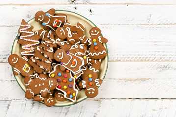 Christmas homemade gingerbread cookies on white wooden table