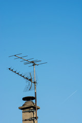 Old TV antenna with a blue sky