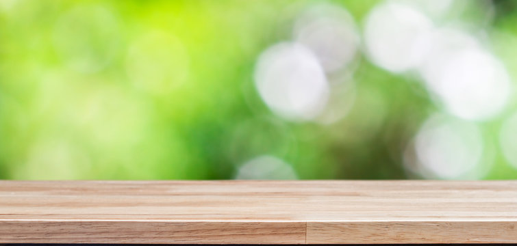 Wood table top on bokeh green background