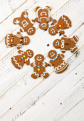 Christmas homemade gingerbread cookies on white wooden table