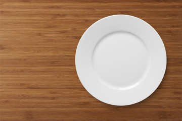 White empty plate on a wooden table