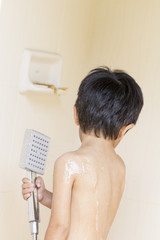 Boy under the shower at home