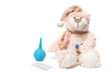 teddy bear with a thermometer and pills