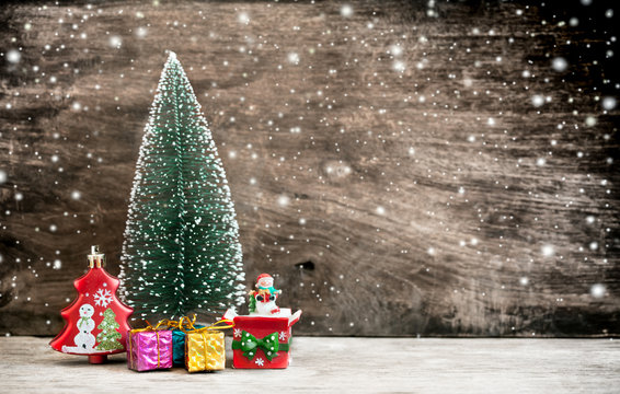 Christmas decoration on wooden background with snow in vintage c