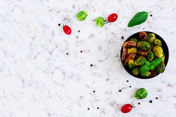 Roasted brussels sprouts with bacon on white background. Top view