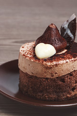 Cake on a clay plate on a wooden background