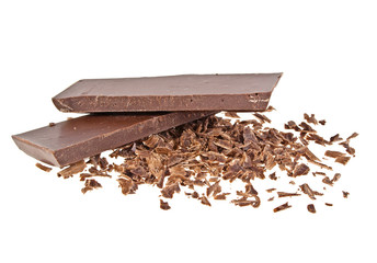 Heap of chocolate shavings and slices on white background