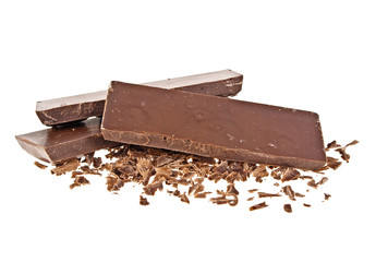 Heap of chocolate shavings and slices on white background