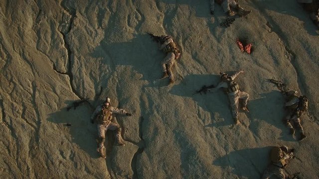 Flying over Group of Dead Soldiers in Desert Area. Zooming Out. Shot in 4k (UHD)