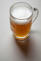 Mug of beer on gray