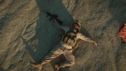 Flying over Group of Dead Soldiers in Desert Area. Zooming Out. Shot in 4k (UHD)