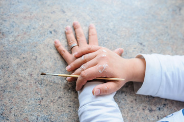 hand of painter brush white paint on hand view nice