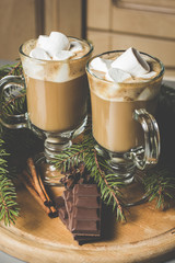 Hot cocoa with marshmallows and chocolate on a wooden board