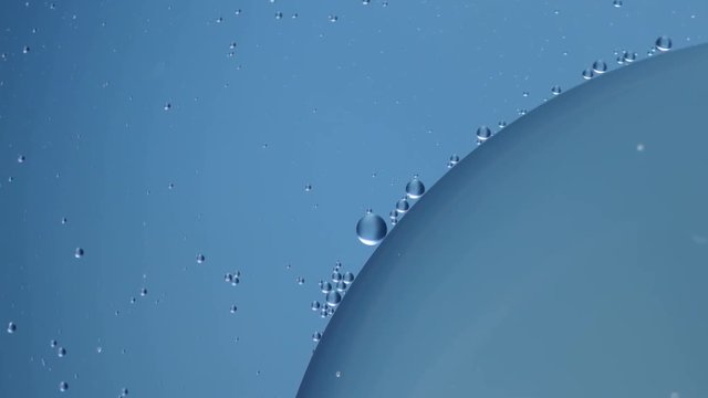 Oil babbles on water, abstraction video. Macro