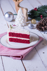 Christmas cake on plate on red fabric on wood background and dec