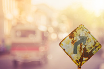 Traffic sign,old curve road sign on blur traffic road abstract background.