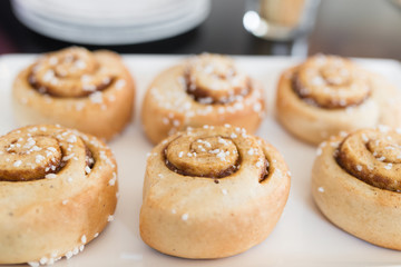 Cinnamon rolls on white plate.