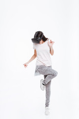 Young happy lady wearing virtual reality device while jumping