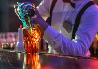 Bartender is making cocktail at bar counter
